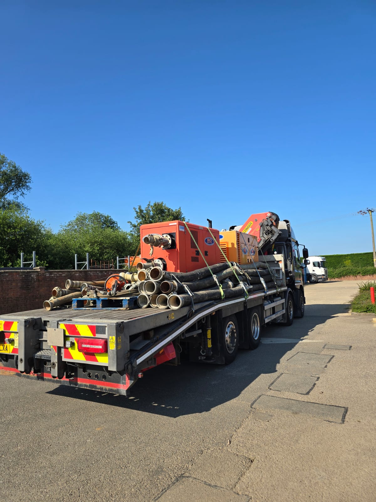 Steel beam lifted by HIAB truck